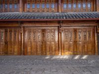 old wooden double doors set in an ancient building in china's beijing suburbs,