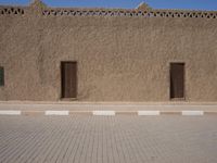 a very wide brick and concrete wall with street lamps on top of it in the middle of the street