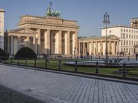 people walking around a walkway outside the brandenburg brandenburg arch in germany during the day time