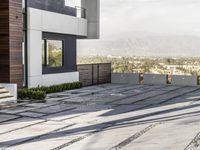 the exterior and landscape of a modern house in los angeles, california with stone and wood