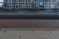 a red fire hydrant sitting in front of a building that looks like a glass block