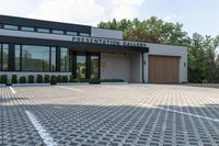 an architectural office building designed to look like an exhibition gallery, and is surrounded by a nice cobblestone area