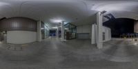 a big round picture in the center of a building with several lights and stairs going to different buildings