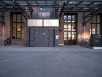 the entrance to the old warehouse with industrial iron doors and bicycles in the background in a city setting