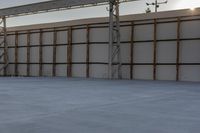 a person jumping a skate board in an empty building with a roof on it's side