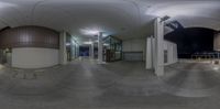 a big round picture in the center of a building with several lights and stairs going to different buildings