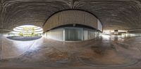 a large concrete building that looks like it has a curved area to sit on and act as a pool