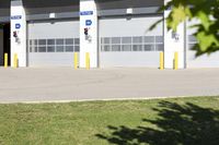 an empty industrial parking garage is located in the daytime light with no cars visible around the entrance