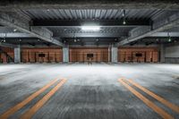 empty parking garage with open doors and stairs up to it's ceiling and steps