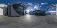 a picture taken from a fish - eye view of an architecturally designed building, reflecting the sky