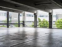 a large room has floor to ceiling windows in it and metal grates covering it