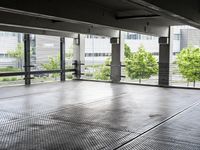 a large room has floor to ceiling windows in it and metal grates covering it