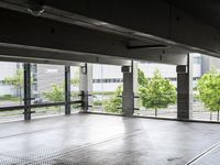 a large room has floor to ceiling windows in it and metal grates covering it