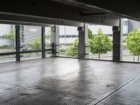 a large room has floor to ceiling windows in it and metal grates covering it