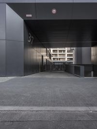 there are several doors leading to the building in this photo, but there is no one who does not have a car