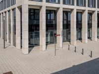 some red signs that are on the ground near a building with a building in the background