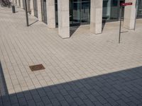 some red signs that are on the ground near a building with a building in the background