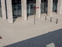 some red signs that are on the ground near a building with a building in the background