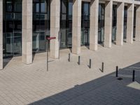 some red signs that are on the ground near a building with a building in the background