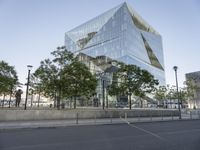 an office building has a curved design with glass walls on the facade on the corner