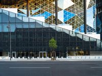 the black glass wall on the building looks very modern and it is empty to see