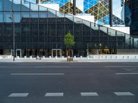 the black glass wall on the building looks very modern and it is empty to see