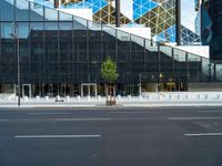 the black glass wall on the building looks very modern and it is empty to see