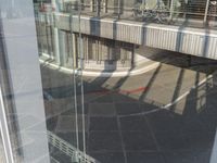 reflection of a bike in the window of an office building or apartment building by itself