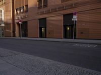 a street that has a sign on it by some buildings on a city street,