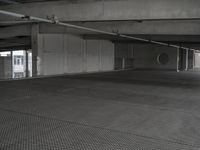 a room with a light next to a parking garage with a ramp and a large open space area