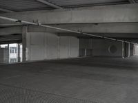 a room with a light next to a parking garage with a ramp and a large open space area