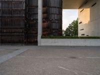 an empty parking lot with several wooden buildings in the background / photo by david b wright