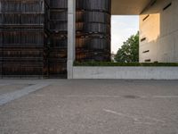 an empty parking lot with several wooden buildings in the background / photo by david b wright