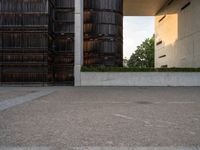 an empty parking lot with several wooden buildings in the background / photo by david b wright