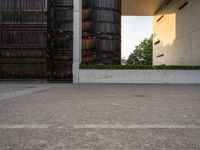 an empty parking lot with several wooden buildings in the background / photo by david b wright