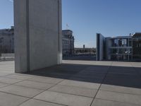 the walkway is concrete and has glass walls and glass doors on it's sides