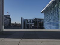 the walkway is concrete and has glass walls and glass doors on it's sides