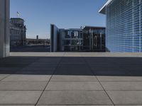 the walkway is concrete and has glass walls and glass doors on it's sides