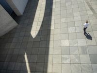 the shadow of a skateboarder in a bathroom on the tiled floor outside a bathtub