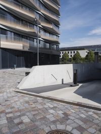 a brick building with glass windows and sidewalk leading to it and a black fire hydrant