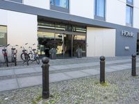 a gray office building with large windows and the name ottello in front of it