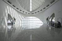 the roof of a building with multiple windows is white in color and has metal rods