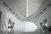 the roof of a building with multiple windows is white in color and has metal rods