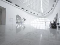 the roof of a building with multiple windows is white in color and has metal rods