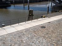 a red fire hydrant is sitting beside the walkway, with two fire hydrants in the middle