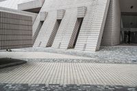 a small courtyard with bricks around the corner and a bench under it to sit on