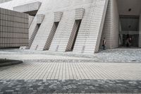 a small courtyard with bricks around the corner and a bench under it to sit on