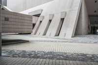 a small courtyard with bricks around the corner and a bench under it to sit on