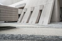 a small courtyard with bricks around the corner and a bench under it to sit on