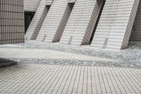 a small courtyard with bricks around the corner and a bench under it to sit on